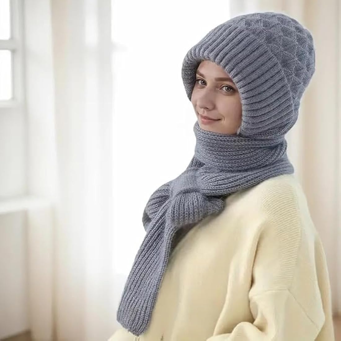 Woman wearing handmade knitted grey beanie and scarf for winter